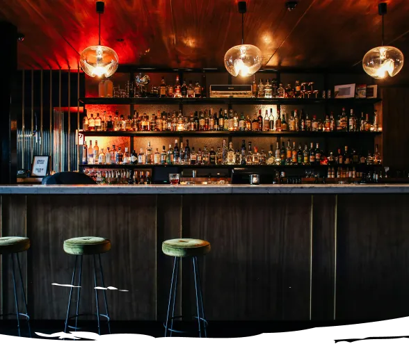 Bar counter with backlit shelves at Frequency pub