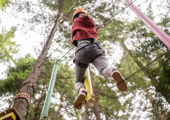 Guest balancing on the high rope course