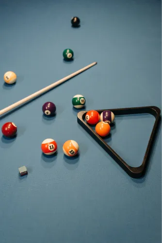 Billiards balls racked on a blue table