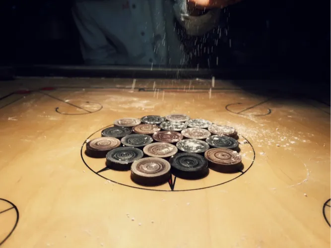 Carrom board with coins ready to play