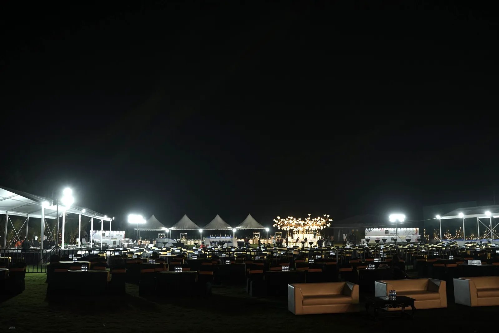 Lawn dinner set-up under the lights for the family New Year party at Sportico Resorts, Bangalore