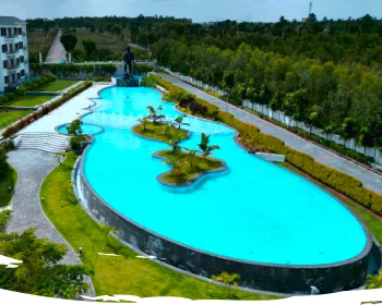 Infinity pool with palm islands at Sportico Resorts near Bangalore