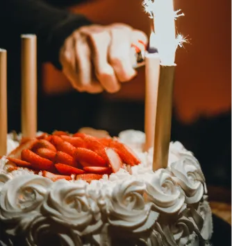 Candle being placed on a birthday cake