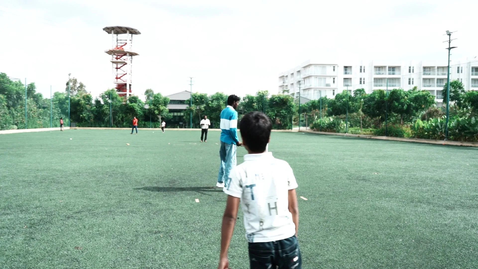 Cricket match on the turf ground at Sportico Resorts