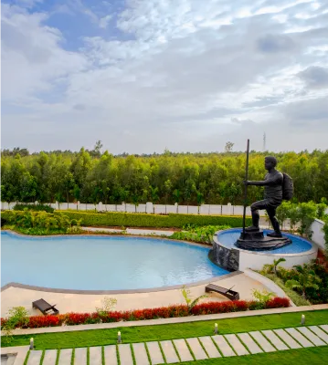 Bronze statue beside the pool at Sportico Resorts near Bangalore